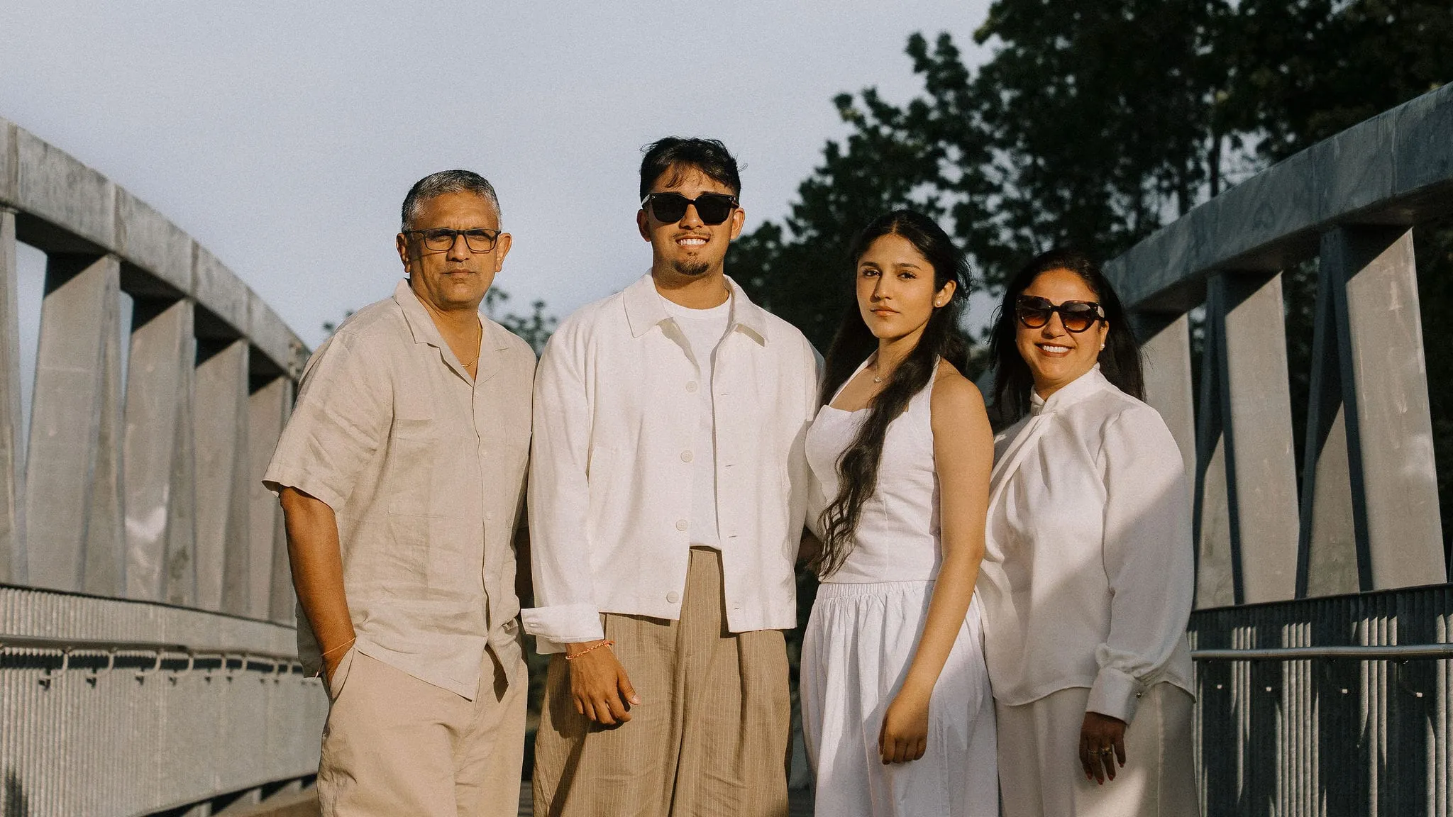 Dev Vashi with his father, sister and mother on a footbridge at golden hour
