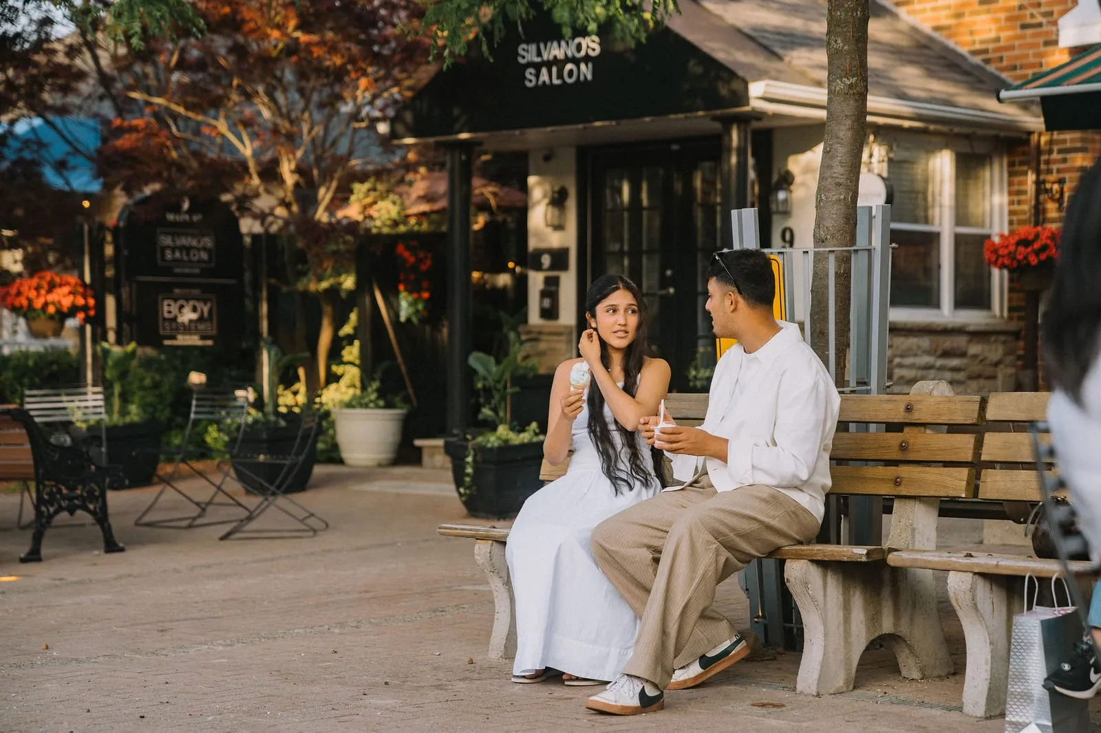 Dev and his sister with ice cream on a bench outside Silvanos Salon in Streetsville